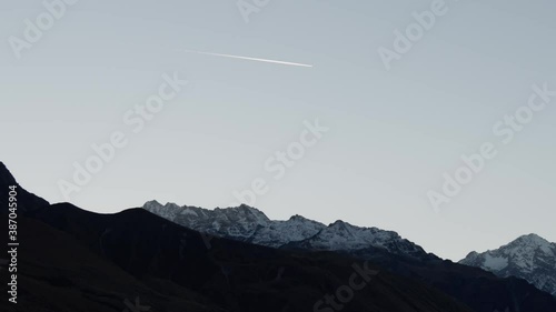 New Zealand autumn season landscape with mountains during sunset in Mt.Cook. Contrail in the sky. photo