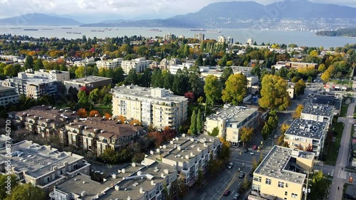 Aerial view of Vancouver neighbourhood with green, orange trees on a sunny day