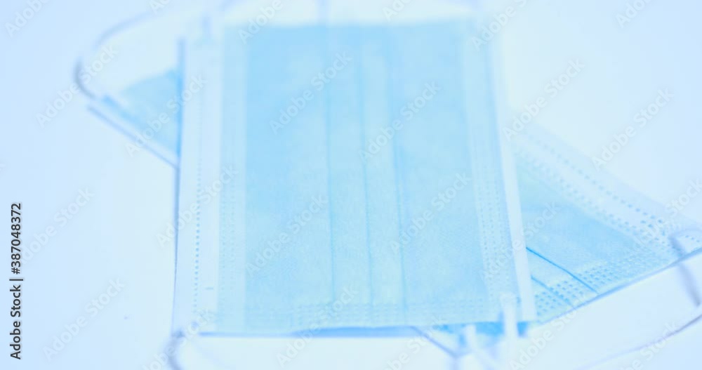Facemask surgical mask on rotating table background stock 4K video Facemask surgical mask on rotating table background stock 4K video