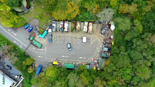 Time lapse of aerial view of people in cars taking garbage to waste recycling centre which is surrounded by green trees. Various containers with different rubbish, environmental. Social Distancing. photo