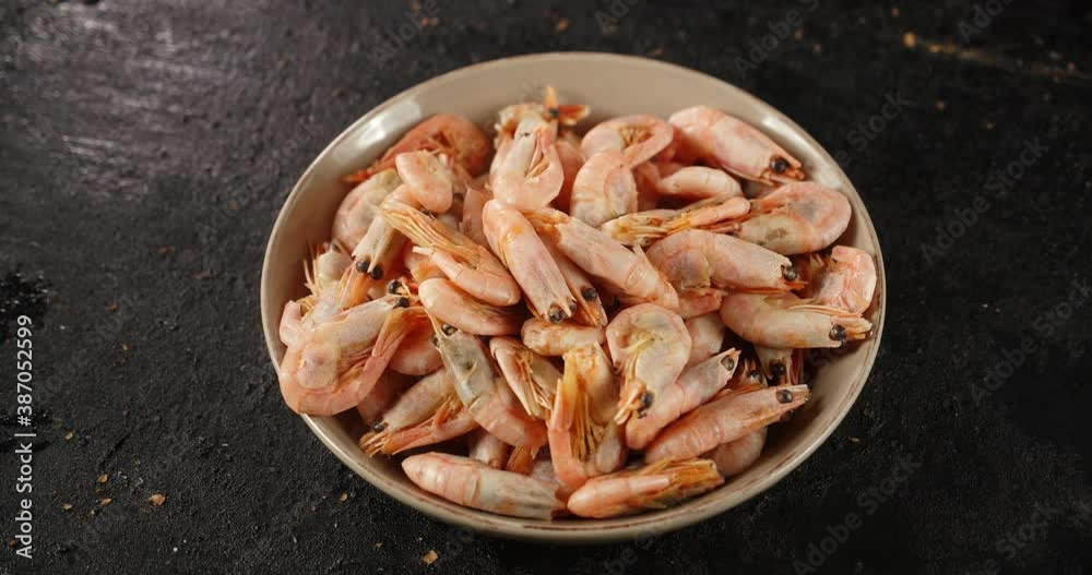 Bowl with boiled shrimp slowly rotates on the table. Bowl with boiled shrimp slowly rotates on the table.