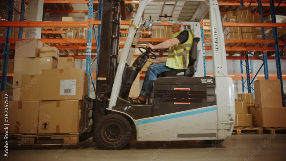 Retail Warehouse full of Shelves with Goods in Cardboard Boxes, Workers Scan and Sort Packages, Move Inventory with Pallet Trucks and Forklifts. Product Distribution Logistics. Slow Motion Ground Shot