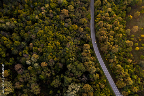 Aerial view of road through the autumn forest. Orfű, Hungary. Drone photography. 