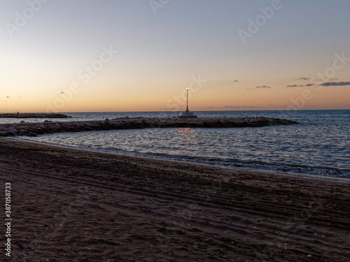 view of the sea and Lamppost on the Pedregalejo Beach at dusk