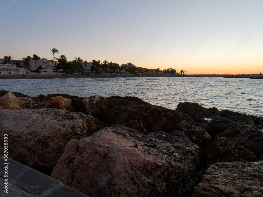 view of the sea and stones on the Pedregalejo Beach at dusk