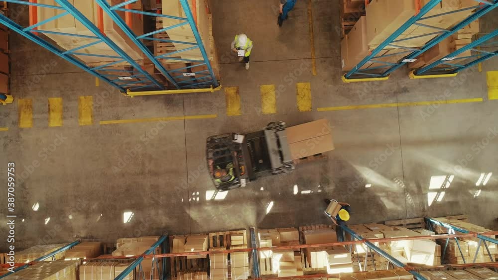 Top-Down View: In Warehouse People Working, Forklift Truck Operator Lifts Pallet with Cardboard Box. Logistics, Distribution Center with Products Ready for Global Shipment, Customer Delivery