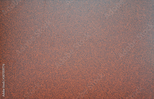 Dark brown granite interspersed with black fine fraction, polished surface of natral stone close-up. photo