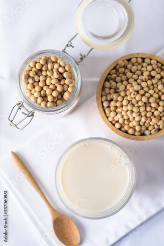Soy milk in glass and soy bean on white background	