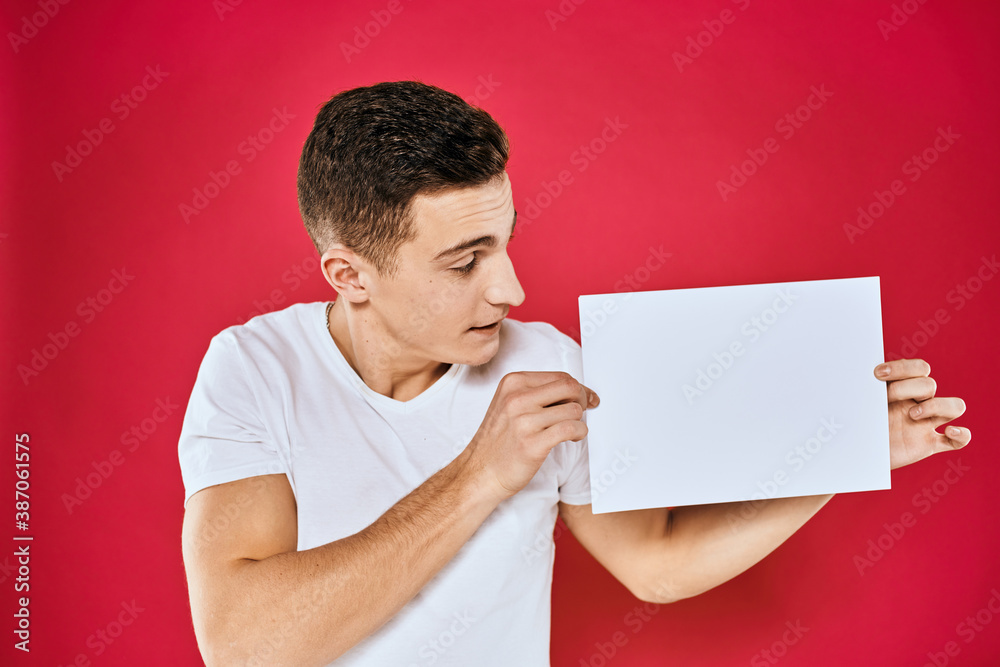 man holding white sheet copy space office close-up red background man holding white sheet copy space office close-up red background