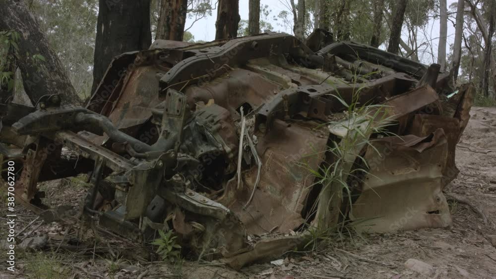 Abandoned flipped car in Australian bushland front on low angle truck right. Abandoned flipped car in Australian bushland front on low angle truck right.