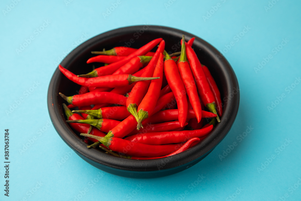 hot red chili, on blue background hot red chili, on blue background