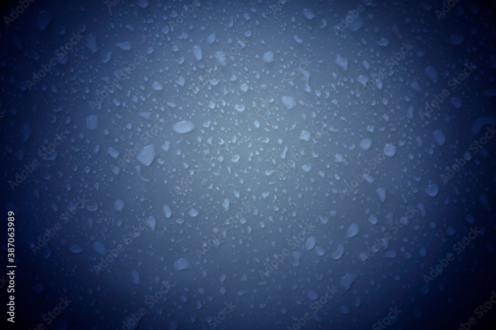 Water droplets on a blue background.Cooling symbol and relaxation.