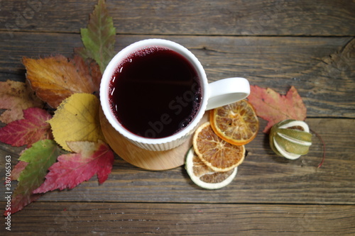 Hot fruit tea with lemon on a wooden background. Selective focus.Still life, food and drink, seasonal concept. 
