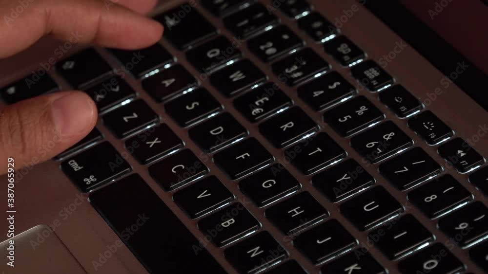 Hands typing on a laptop keyboard.