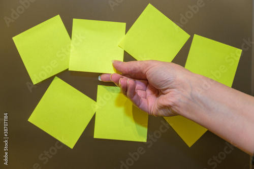 businesswoman attaching yellow sticky notes on flip chart. mockup with copy space.