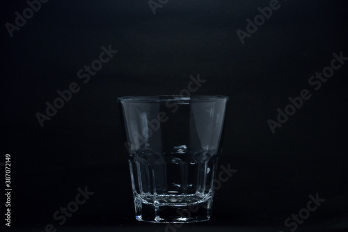A 100 ml transparent glass on a black background