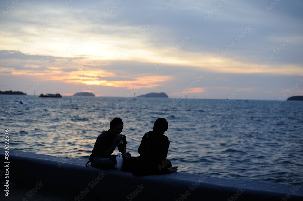 Romantic sunset over the sea with dramatic clouds in the sky perfect for a date