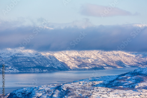 Beautiful winter landscape with mountains and fjord