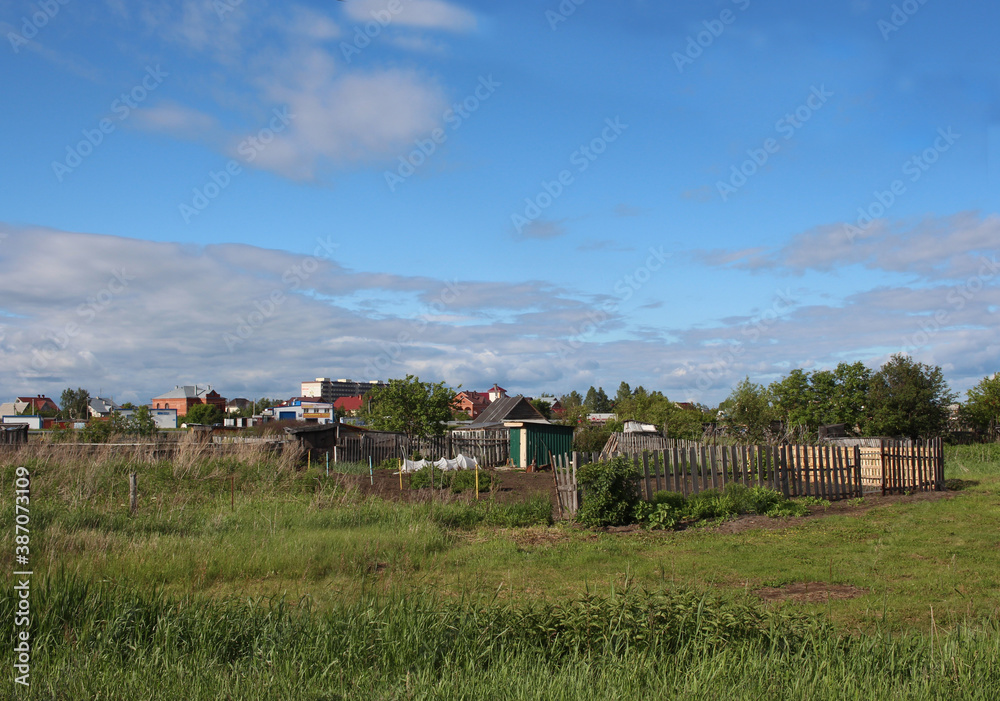 village with fences and old rural houses in summer landscape village with fences and old rural houses in summer landscape