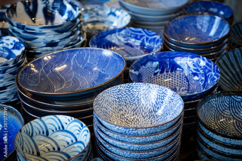 An isolated, slightly downward, view of stacks of blue and white patterned porcelain bowls 