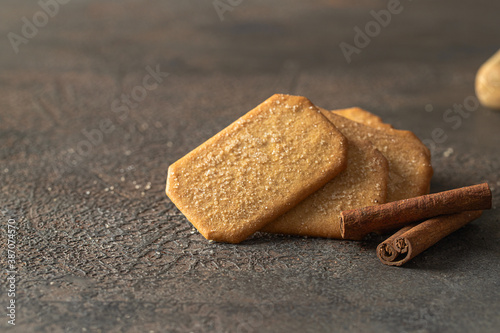 Cinnamon sugar  crackers  and cinnamon sticks on concrete background. Copy space photo