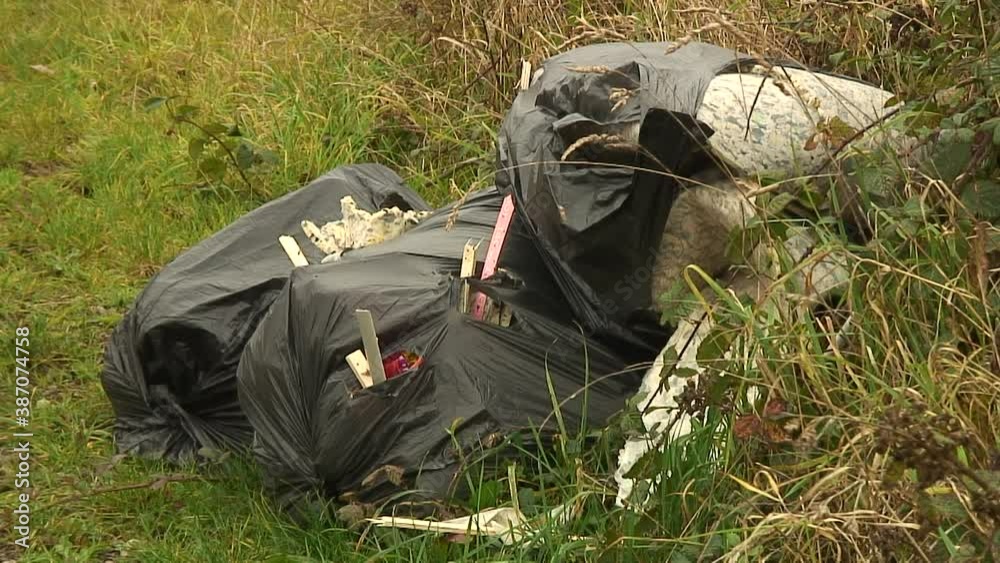 Criminals dump carpet rubbish in a field gateway spoiling the rural English countryside Criminals dump carpet rubbish in a field gateway spoiling the rural English countryside