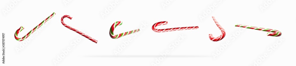 Obraz premium Flying traditional Christmas candy cane, lollipop on white background flat lay. Creative new year food concept. Festive decor, sweetness, caramel candy. Christmas holiday symbol, decoration