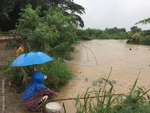 People sitting by the river for fishing are a way of life in Asia. photo