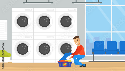 Public Laundrette with Laundromat Washing Machines, Man Loading Clothes for Washing and Drying Cartoon Vector Illustration