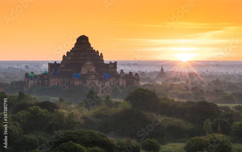 Pagoda landscape of Bagan in misty morning under a warm sunrise in the plain of Bagan