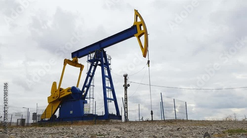 Oil pumpjack pumping sequentially oil from the ground near Ploiesti, Romania photo