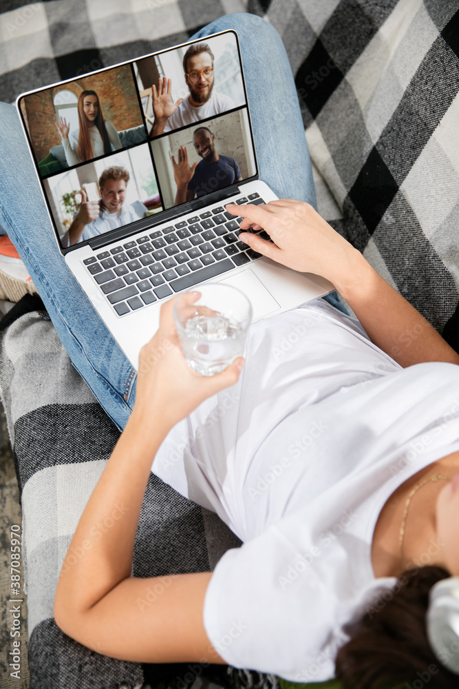 Fototapeta premium Meeting online, education. Remote working from home. Workplace in home office on sofa with laptop and devices. Concept of distance learning, isolation, female business, shopping online, conference.