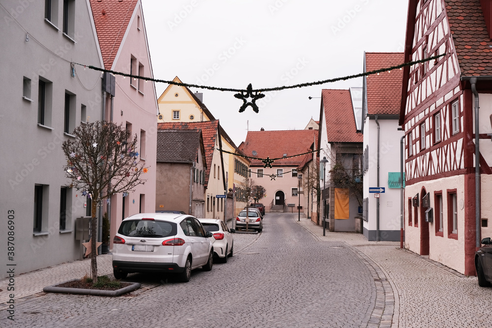 Christmas and New Year in Europe. Christmas holidays in Germany.festive Christmas decor on the streets of Europe. European Houses with red roofs.traditional German style fachwerk houses background. 