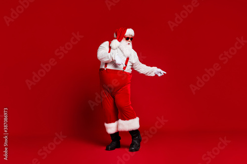 Full length body size view of his he attractive cool funny fat white-haired Santa dancing having fun chill rest relax isolated bright vivid shine vibrant red burgundy maroon color background