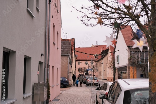 Christmas and New Year in Europe. Christmas holidays in Germany.festive Christmas decor on the streets of Europe. European Houses with red roofs.traditional German style fachwerk houses background.  © Yuliya