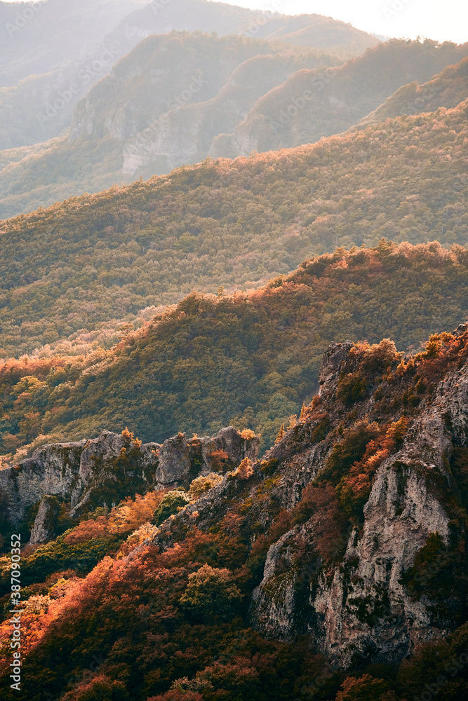 Sunset over the mountain peak with maple in autumn time in Seto Inland Sea, Japan.