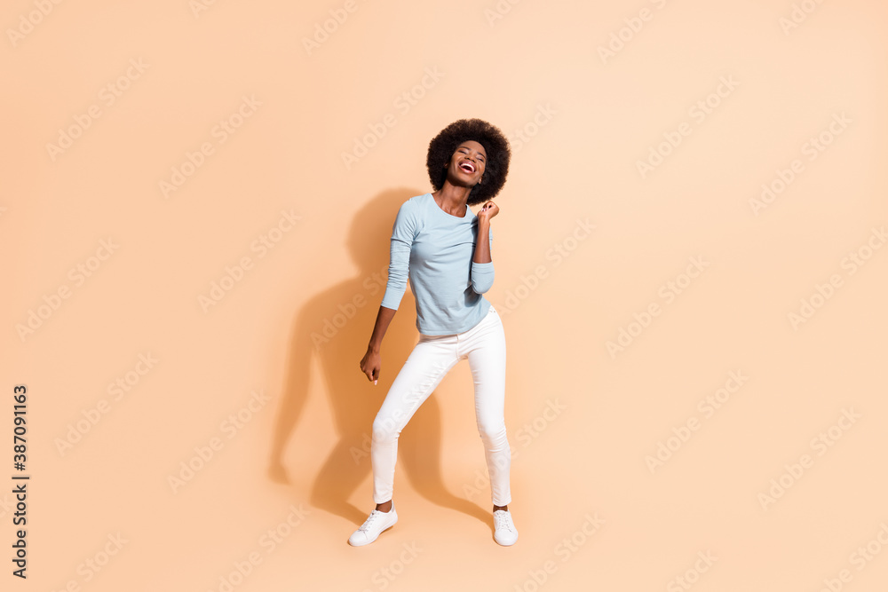 Photo portrait full body of energetic african american girl dancing isolated on pastel beige colored background