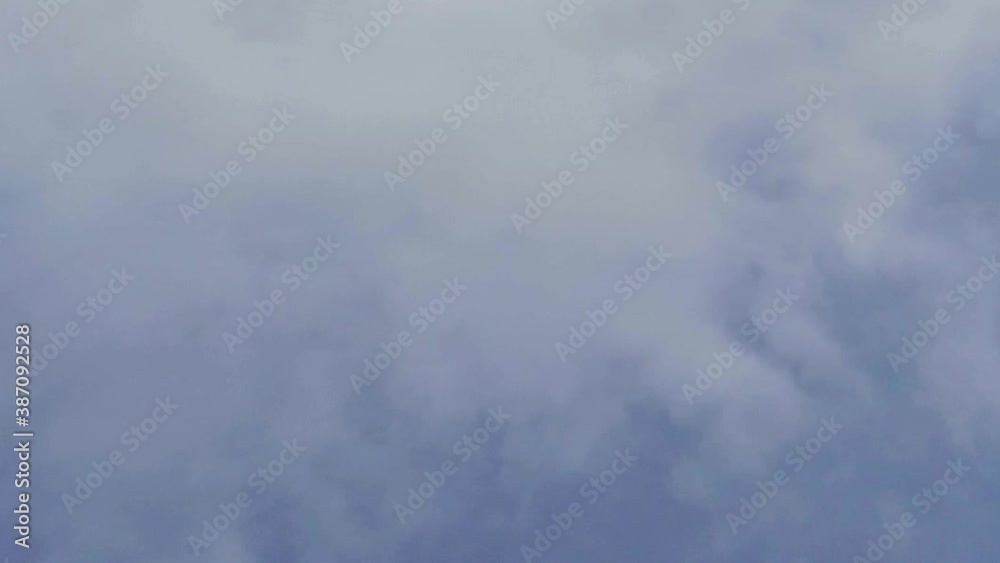 Looking up at blue sky with grey and white powder clouds. Vertical panning shot Looking up at blue sky with grey and white powder clouds. Vertical panning shot