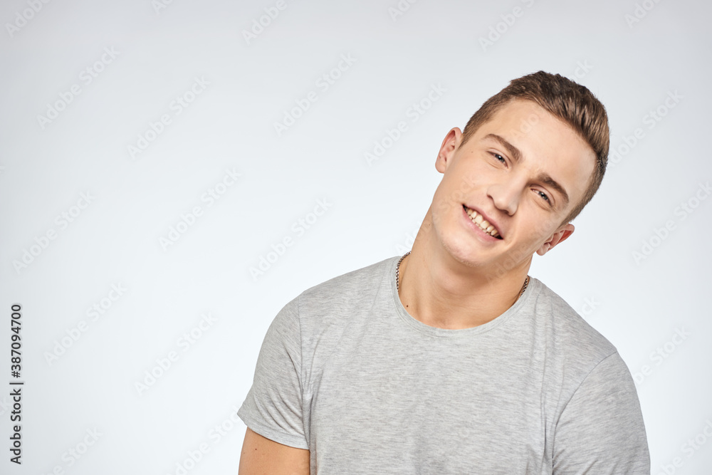 man in gray t-shirt emotions light background cropped view man in gray t-shirt emotions light background cropped view