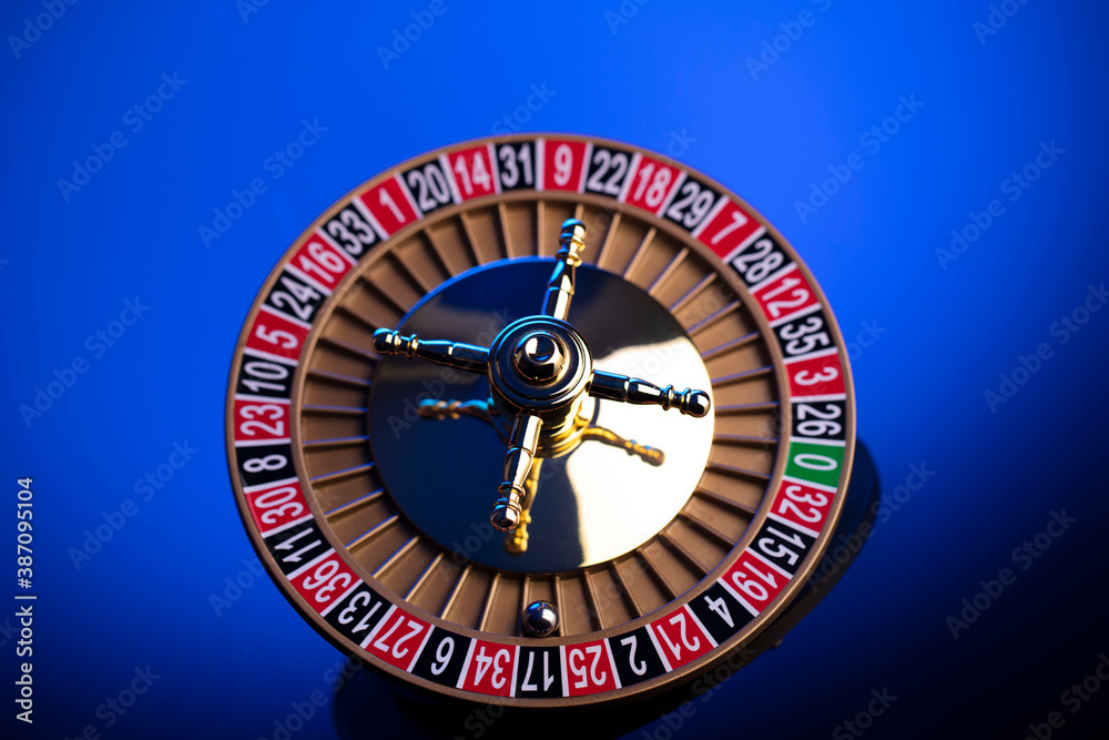 Casino theme, close up of roulette, red and black numbers. Blue background. Casino theme, close up of roulette, red and black numbers. Blue background.