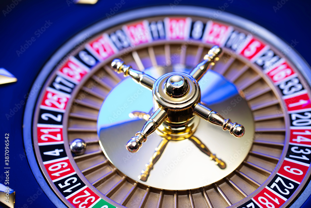 Casino theme, close up of roulette, red and black numbers. Blue background. Casino theme, close up of roulette, red and black numbers. Blue background.