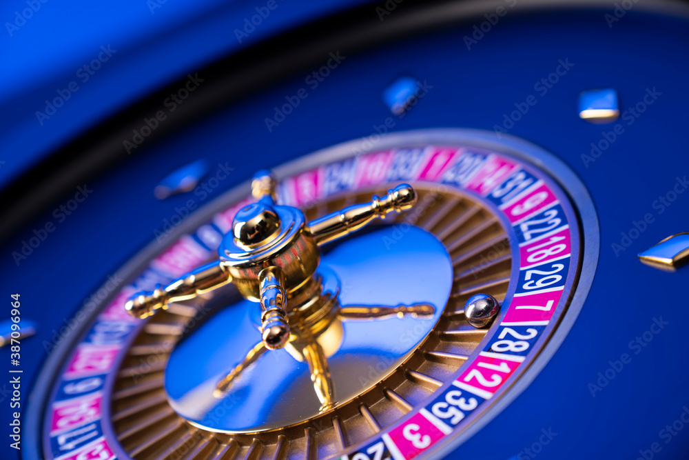 Casino theme, close up of roulette, red and black numbers. Blue background. Casino theme, close up of roulette, red and black numbers. Blue background.