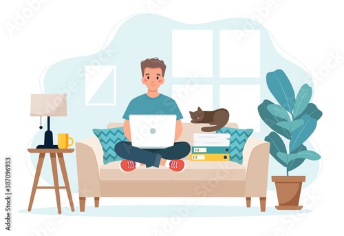 Home office concept, man working from home sitting on a sofa, remote work concept