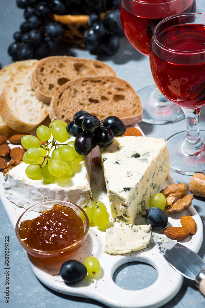 cheese plate, fresh grapes and red wine, vertical top view cheese plate, fresh grapes and red wine, vertical top view