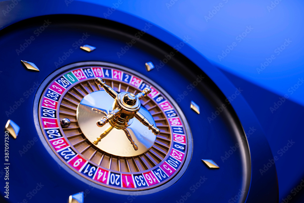 Casino theme, close up of roulette, red and black numbers. Blue background.