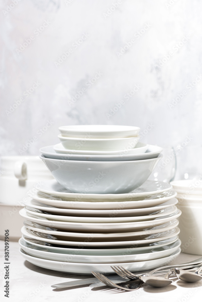 empty tableware and cutlery on a white background, vertical empty tableware and cutlery on a white background, vertical
