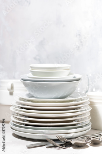 empty tableware and cutlery on a white background  vertical