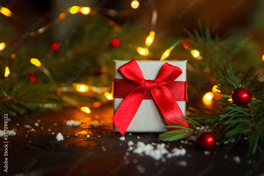 Christmas greeting card concept. Gift box with christmas tree and lights. Copy space