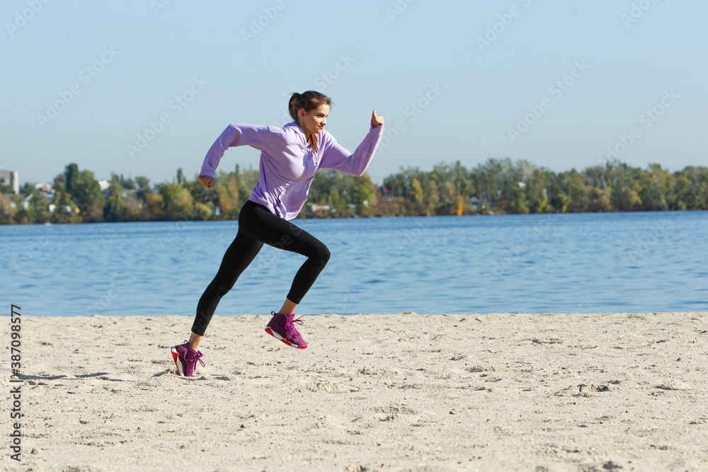 On the go. Young female athlete, woman training, practicing outdoors in autumn sunshine. Beautiful caucasian sportswoman running open-air. Concept of sport, healthy lifestyle, movement, activity.
