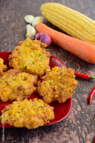 Indonesian corn fritters or Bakwan Jagung served with red chilies